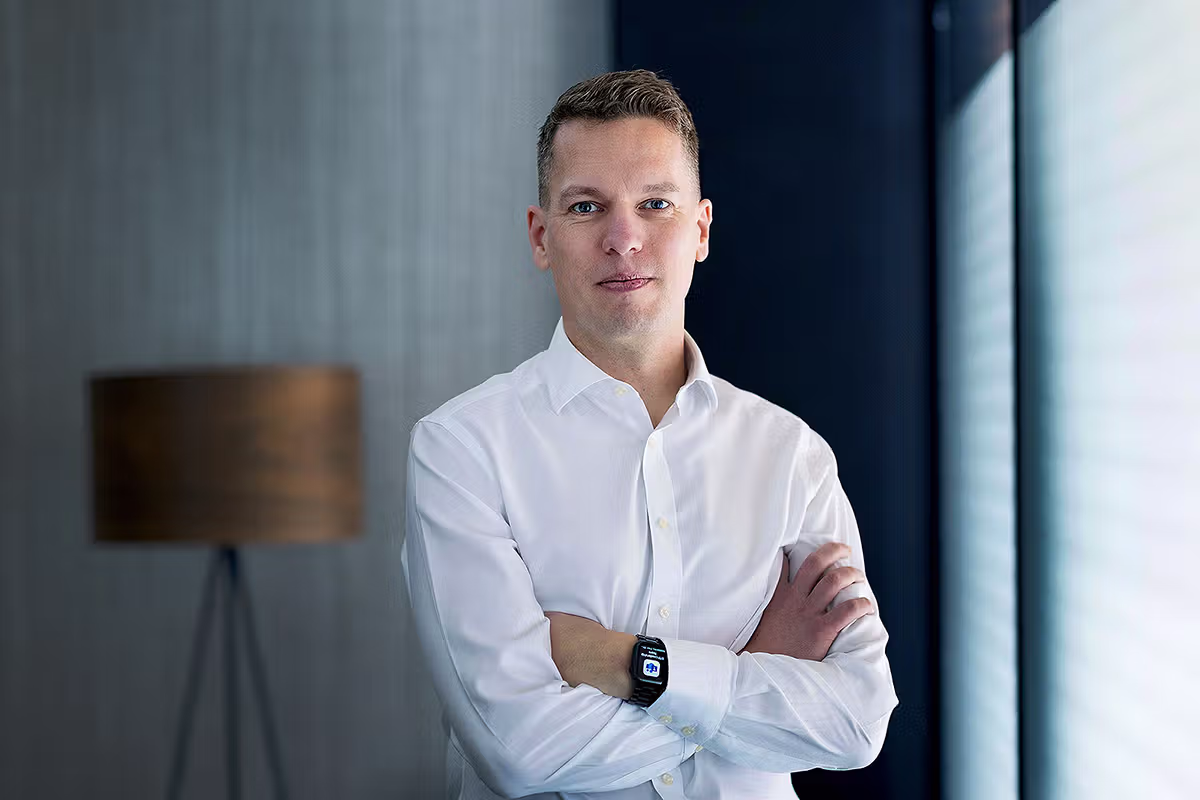 Corporate photographer UK environmental portrait of a business professional in a modern office.