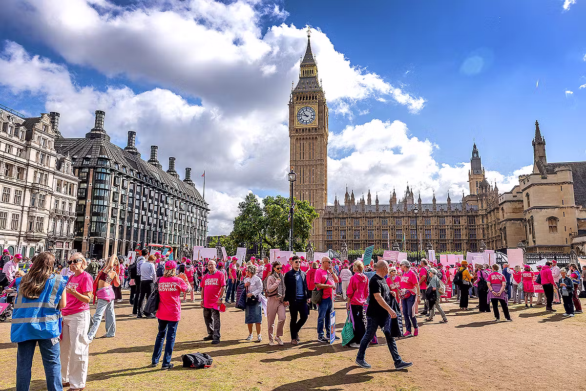 Event photographer London coverage of a Westminster public affairs campaign event outside Parliament with Big Ben, supporters, placards and banners.
