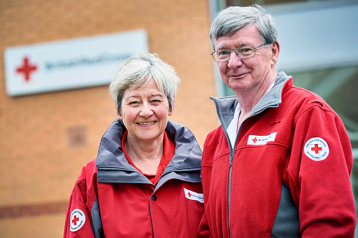 Two British Red Cross volunteers photographed outside a UK Red Cross centre.